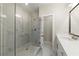 Bathroom with a glass door walk-in shower, double sinks, and marble tile flooring at 1417 Coretta Scott Bnd, Atlanta, GA 30318