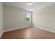 Cozy bedroom with hardwood floors and a window offering natural light and green views at 1417 Coretta Scott Bnd, Atlanta, GA 30318