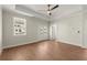Bright bedroom with hardwood floors, a ceiling fan, neutral paint colors, and backyard access at 1417 Coretta Scott Bnd, Atlanta, GA 30318