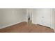 Bedroom with hardwood floors and hall access provides ample natural light and closet storage at 1417 Coretta Scott Bnd, Atlanta, GA 30318