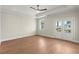 Spacious bedroom featuring tray ceilings, hardwood floors, a ceiling fan, and double doors at 1417 Coretta Scott Bnd, Atlanta, GA 30318