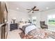 Bright bedroom with a ceiling fan, a cozy rug, and a comfy sitting area at 1417 Coretta Scott Bnd, Atlanta, GA 30318