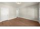 A bright, empty bedroom with hardwood floors, neutral walls, and ample natural light at 1417 Coretta Scott Bnd, Atlanta, GA 30318