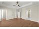 Bedroom featuring hardwood flooring, tray ceilings, neutral colors, and ensuite bathroom access at 1417 Coretta Scott Bnd, Atlanta, GA 30318