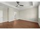 Bedroom featuring tray ceilings, hardwood floors, a neutral color, and an attached bathroom at 1417 Coretta Scott Bnd, Atlanta, GA 30318