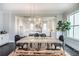 Open concept dining room and kitchen with modern pendant lighting at 1417 Coretta Scott Bnd, Atlanta, GA 30318