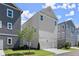 New townhome exteriors featuring neutral siding and manicured lawns at 1417 Coretta Scott Bnd, Atlanta, GA 30318