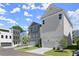 Modern townhome exteriors featuring neutral siding, well-manicured lawns, and private driveways at 1417 Coretta Scott Bnd, Atlanta, GA 30318