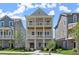 Charming three-story home featuring double porches and a landscaped front yard, perfect for outdoor living at 1417 Coretta Scott Bnd, Atlanta, GA 30318