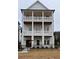 Three-story home with double balconies and a black metal fence at 1417 Coretta Scott Bnd, Atlanta, GA 30318