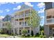 Elegant three-story house with double porches and a well-maintained lawn, ideal for enjoying the outdoors at 1417 Coretta Scott Bnd, Atlanta, GA 30318