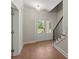 Bright foyer with hardwood flooring, staircase, and a view of the front door at 1417 Coretta Scott Bnd, Atlanta, GA 30318
