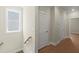 Bright hallway with hardwood floors leads to upstairs, next to window providing natural light, and features convenient storage closets at 1417 Coretta Scott Bnd, Atlanta, GA 30318