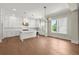 Open-concept kitchen with white cabinetry, a kitchen island, and stainless steel appliances at 1417 Coretta Scott Bnd, Atlanta, GA 30318