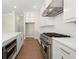 Bright modern kitchen features stainless steel appliances and white cabinetry at 1417 Coretta Scott Bnd, Atlanta, GA 30318