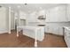 Bright kitchen features white cabinetry, an island, stainless steel appliances, and wood floors at 1417 Coretta Scott Bnd, Atlanta, GA 30318