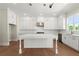Bright open kitchen features white cabinets, a large island, and stainless steel appliances at 1417 Coretta Scott Bnd, Atlanta, GA 30318