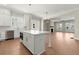 Bright kitchen features a center island, stainless steel appliances, and wood floors at 1417 Coretta Scott Bnd, Atlanta, GA 30318