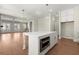 Open kitchen with stainless steel appliances, white cabinets, and view to living room at 1417 Coretta Scott Bnd, Atlanta, GA 30318