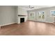 Bright living room boasts hardwood floors, a modern ceiling fan, and a charming fireplace with access to the porch at 1417 Coretta Scott Bnd, Atlanta, GA 30318