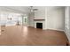 Spacious living area featuring hardwood floors and a fireplace with a wood mantel, seamlessly connecting to the bright kitchen at 1417 Coretta Scott Bnd, Atlanta, GA 30318