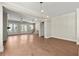 Spacious living room with wood floors, a fireplace, ceiling fan, and french doors at 1417 Coretta Scott Bnd, Atlanta, GA 30318