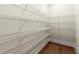 Walk-in pantry offers ample storage with multiple tiers of wire shelving and hardwood floors, ideal for organized living at 1417 Coretta Scott Bnd, Atlanta, GA 30318