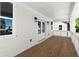 Charming covered porch with double doors and wood flooring, perfect for relaxing outdoors at 1417 Coretta Scott Bnd, Atlanta, GA 30318