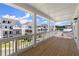 Spacious covered porch with wood flooring and white railings, offering neighborhood views at 1417 Coretta Scott Bnd, Atlanta, GA 30318