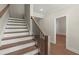 Elegant staircase with wood treads and a dark metal railing at 1417 Coretta Scott Bnd, Atlanta, GA 30318