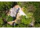 Aerial view of home on landscaped property with mature trees and long driveway at 2025 Goldmine Dr, Cumming, GA 30040