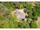 Aerial view of house showcasing backyard, patio and outdoor furniture, complemented by verdant surroundings at 2025 Goldmine Dr, Cumming, GA 30040