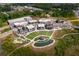 A vibrant aerial view of the community, showcasing lush landscaping, walking paths, and nearby shopping and parking areas at 2025 Goldmine Dr, Cumming, GA 30040