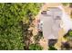 Aerial view displays home with large roof, patio with furniture, lush trees and driveway at 2025 Goldmine Dr, Cumming, GA 30040