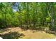 Mature hardwood trees create privacy in the backyard of this home at 2025 Goldmine Dr, Cumming, GA 30040