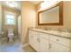 Bathroom with white vanity, marble countertop, window, and shower with white curtains at 2025 Goldmine Dr, Cumming, GA 30040