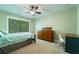 Spacious bedroom with ceiling fan, and natural light from the large window at 2025 Goldmine Dr, Cumming, GA 30040