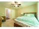 Bedroom featuring a ceiling fan, wooden furniture and a window view at 2025 Goldmine Dr, Cumming, GA 30040