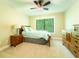 Bedroom with ceiling fan, wooden furniture and window letting in natural light at 2025 Goldmine Dr, Cumming, GA 30040