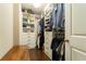 Well-organized walk-in closet featuring built-in shelving and hanging rods at 2025 Goldmine Dr, Cumming, GA 30040