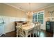 Elegant dining room featuring hardwood floors, chandelier, and a white farmhouse table at 2025 Goldmine Dr, Cumming, GA 30040