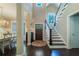 Elegant entryway featuring hardwood floors, staircase, natural light, and view to dining room at 2025 Goldmine Dr, Cumming, GA 30040