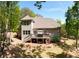 Rear exterior view of this home featuring a large deck and outdoor area at 2025 Goldmine Dr, Cumming, GA 30040