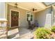 Inviting front porch with rocking chairs, a welcome sign, decorative wreath, and charming curb appeal at 2025 Goldmine Dr, Cumming, GA 30040