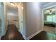 Upstairs hallway with hardwood floors leading to bedroom with ceiling fan at 2025 Goldmine Dr, Cumming, GA 30040