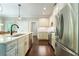 Modern kitchen with stainless steel appliances, granite countertops, and hardwood floors at 2025 Goldmine Dr, Cumming, GA 30040