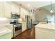 Well-appointed kitchen with stainless appliances, granite countertops, open layout connecting to living area at 2025 Goldmine Dr, Cumming, GA 30040