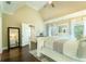 Airy main bedroom with a large bed, hardwood floors, and natural light at 2025 Goldmine Dr, Cumming, GA 30040