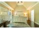 Spacious main bedroom with tray ceilings, neutral colors, and hardwood flooring at 2025 Goldmine Dr, Cumming, GA 30040