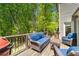 Outdoor patio with comfortable seating surrounded by greenery and a grill at 2025 Goldmine Dr, Cumming, GA 30040